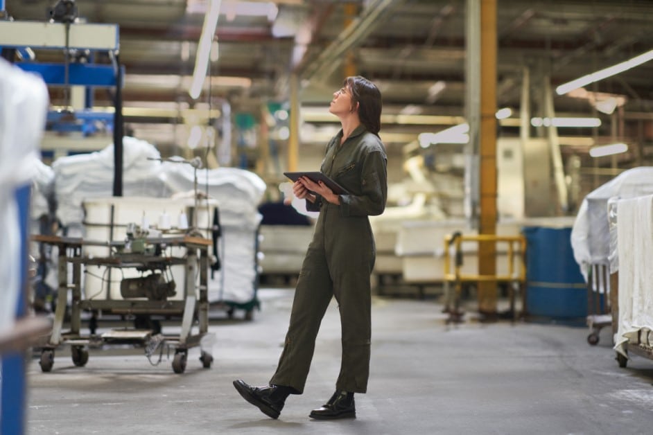 CEO of a textile manufacturing plant managing inventory on the warehouse floor.