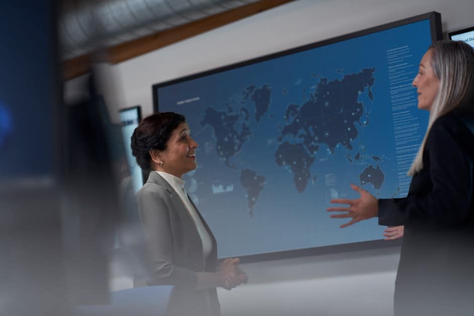 CISO (chief information security officer) collaborating with a practitioner in a security operations center.