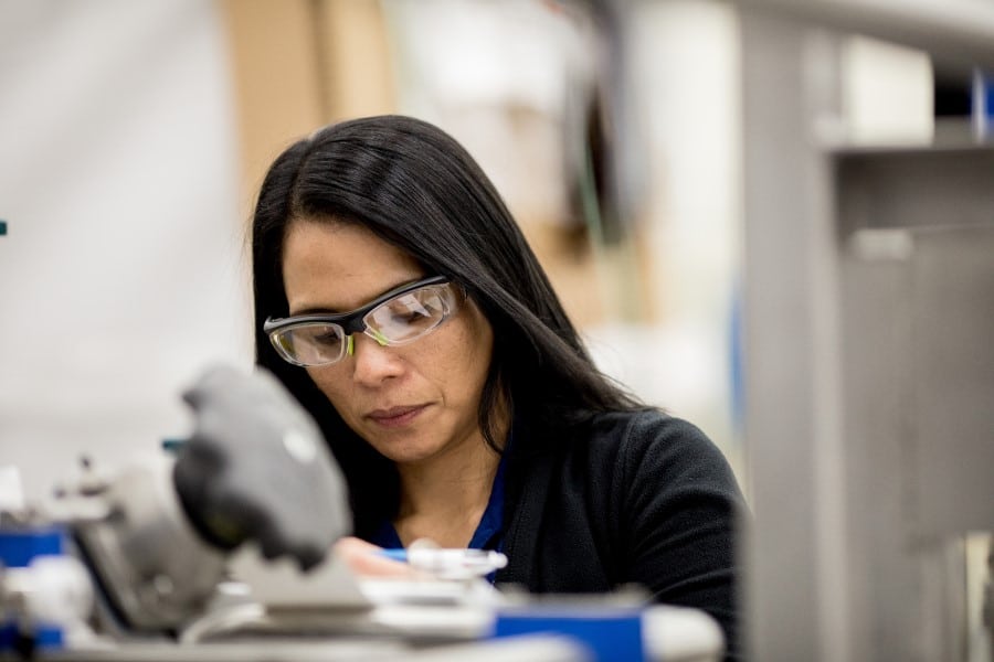 a woman in glasses looking at the camera