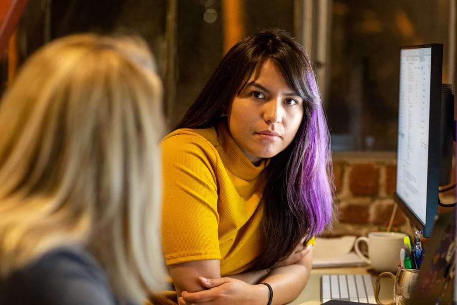 female worker poised in a moment of collaboration with a coworker