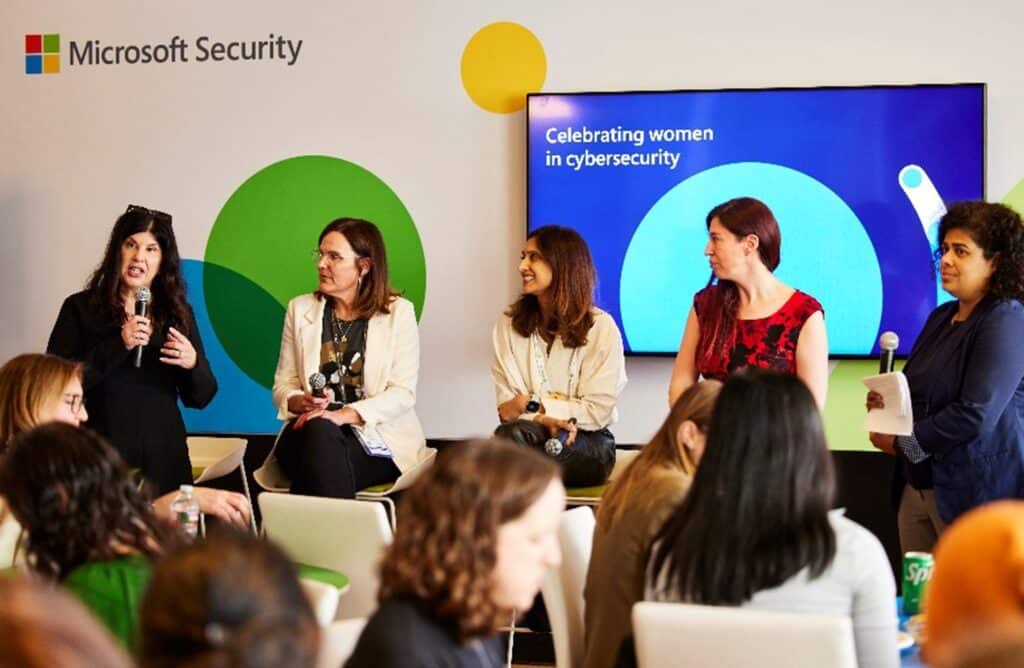 Five women speaking on a panel celebrating women and diversity in cybersecurity