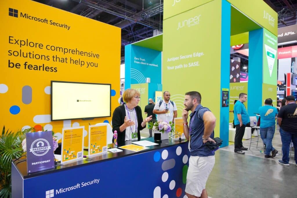 Two people having a conversation at the Microsoft Security Booth at Black Hat Conference 2022.