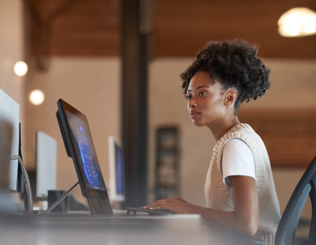 Enterprise office worker in focused work with a neutral facial expression.