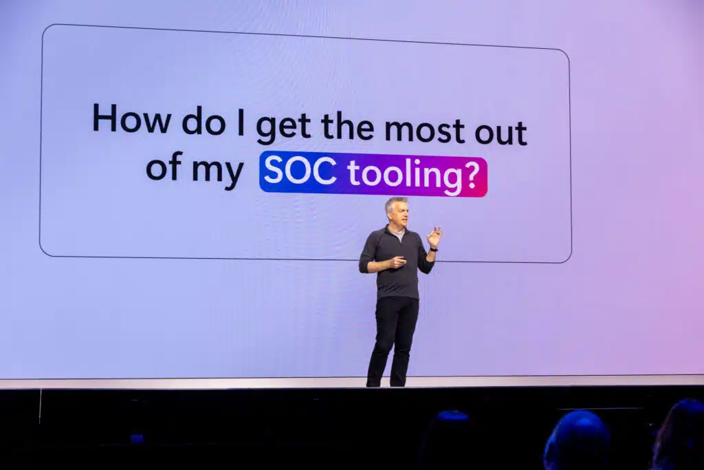 Rob Lefferts on stage in front of slide about SOC tooling.