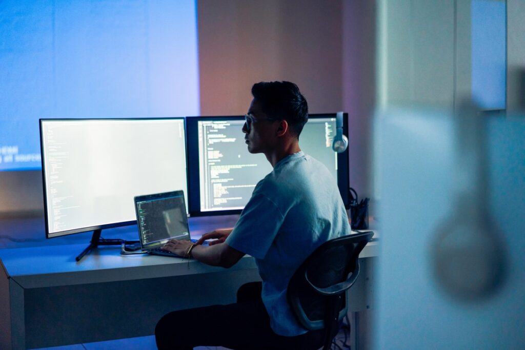 Computer programmer working at night in office.