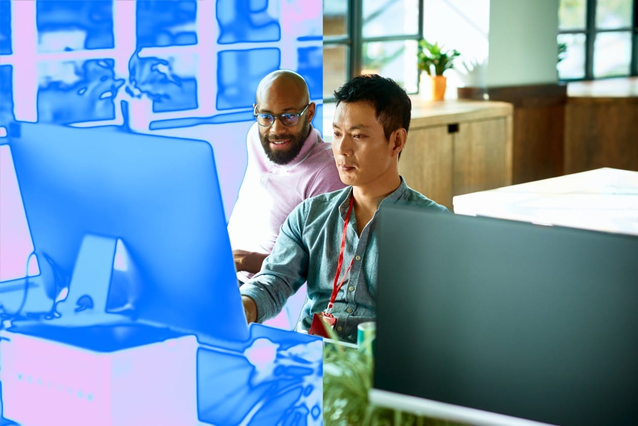 A group of men working on a computer